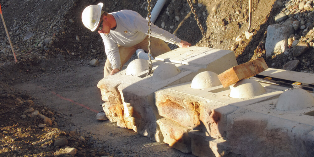 image of worker installing redi-rock block