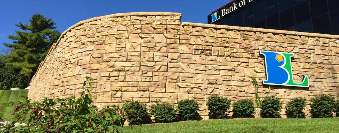 image of curved redi-rock wall with a BL logo on wall
