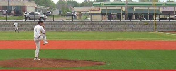 Pitches on baseball field with Cobblestone retaining wall separating the field from the road
