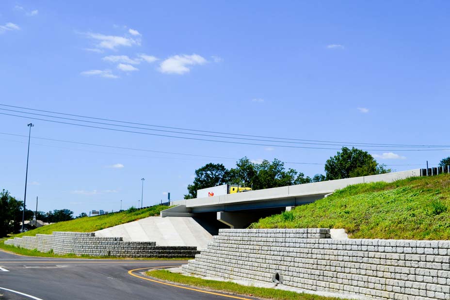 Truck driving on overpass supported by Redi-Rock retaining walls