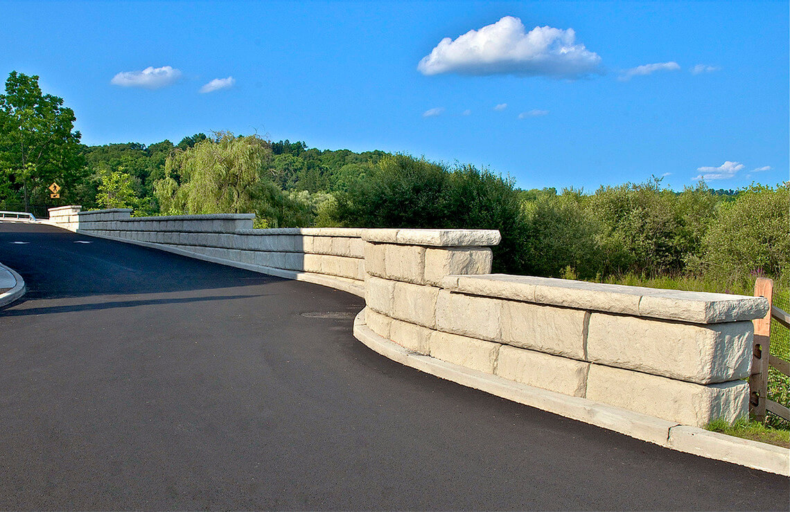 image of redi-rock limestone freestanding wall next to road