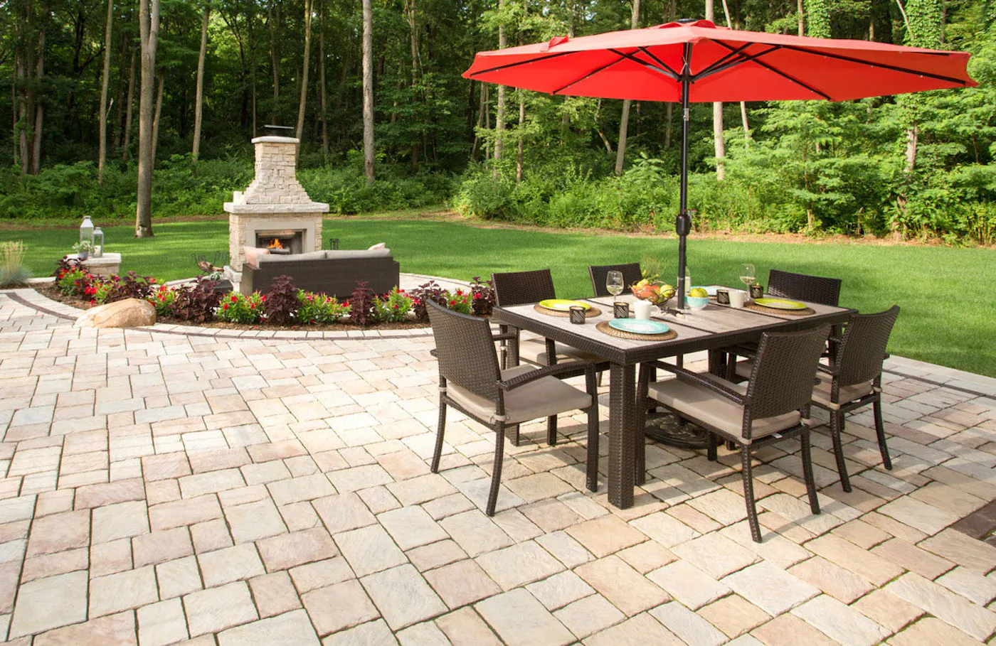 new mission pavers for outdoor lounge area with table, a couch, and outdoor fireplace