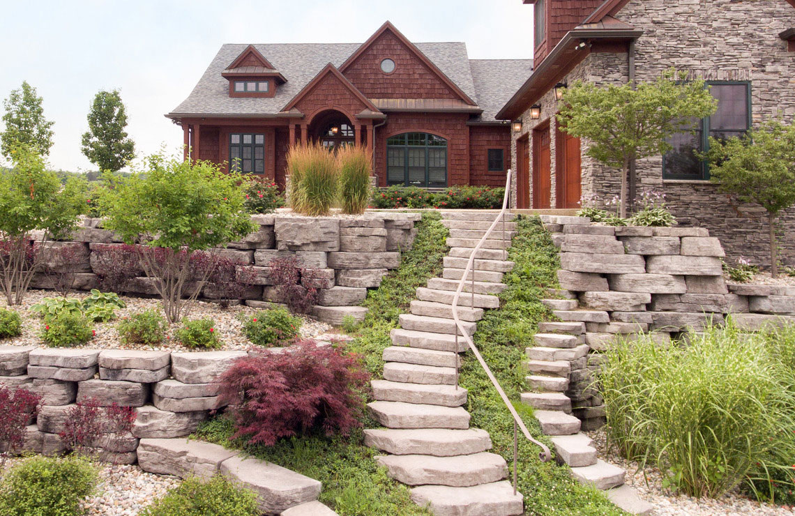 residential home with plants, outcropping wall, and rosetta irregular step stairway