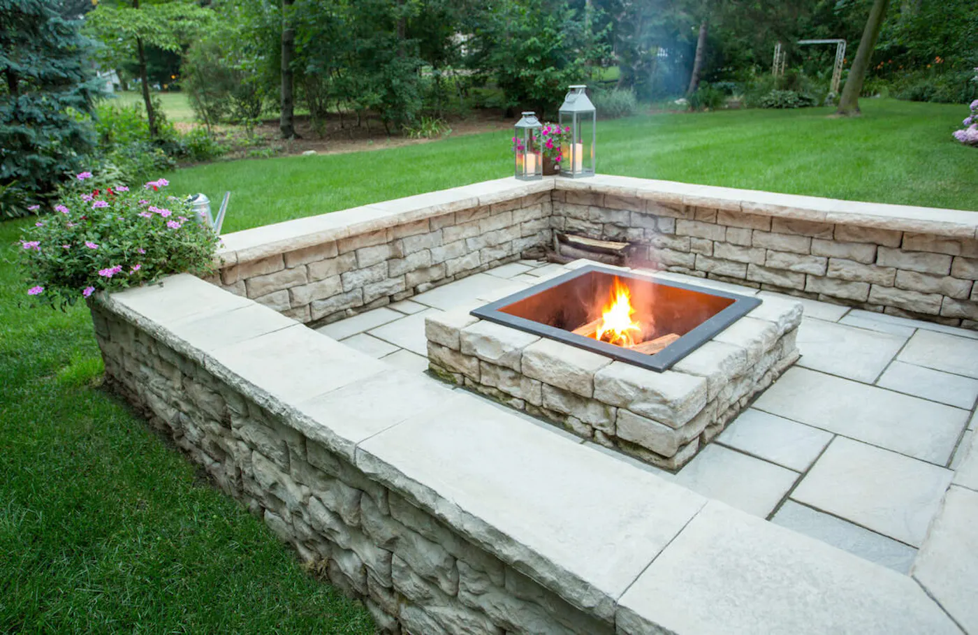 kodah wall for backyard area with potted plants, dimensional coping, and lanterns and dimensional firepit