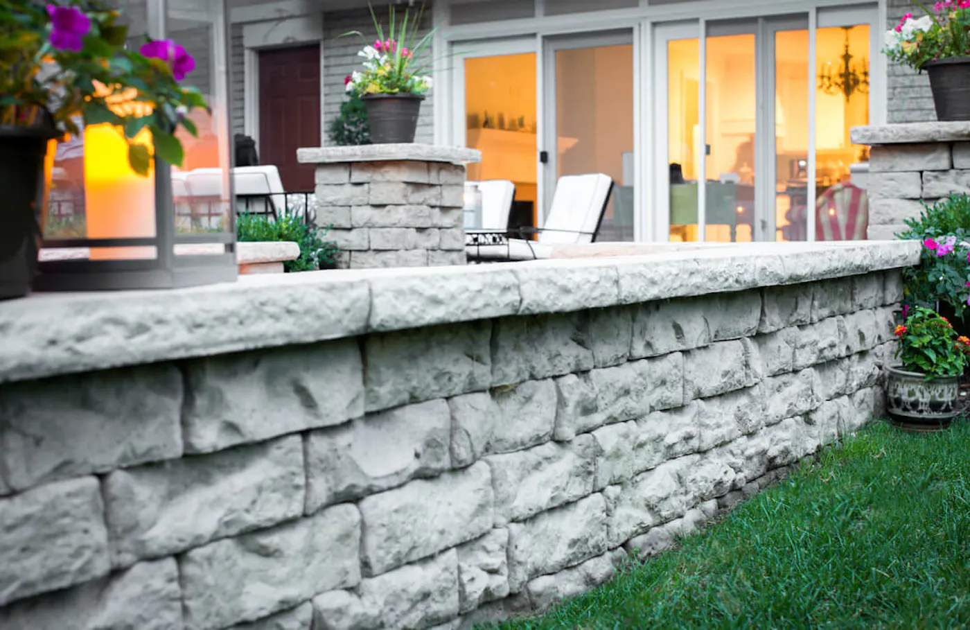 kodah wall for backyard area with potted plants, dimensional coping, and lanterns
