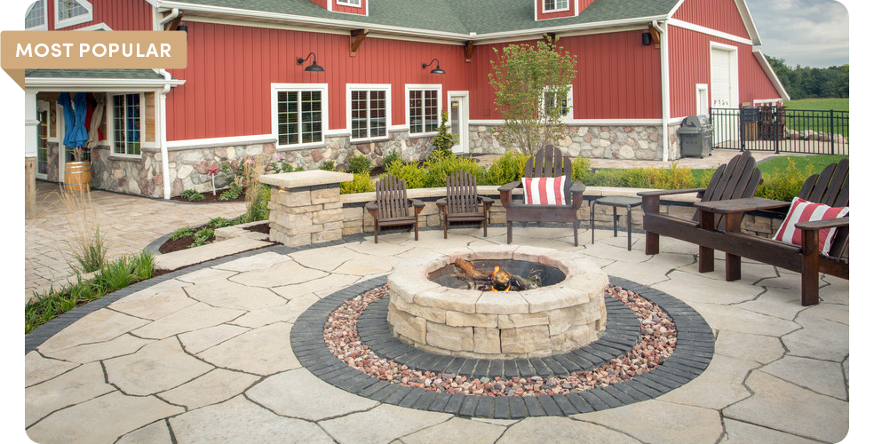 grand flagstone with firepit in front of barn house