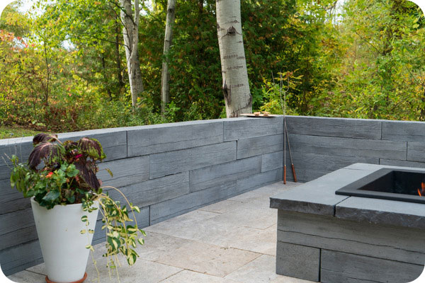 heartwood wall with firepit and plant in vase