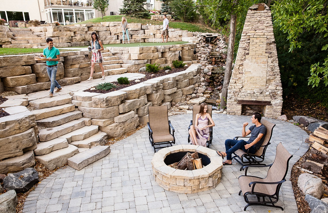 tiered outcropping wall with put-put area, fire pit area, and stairway