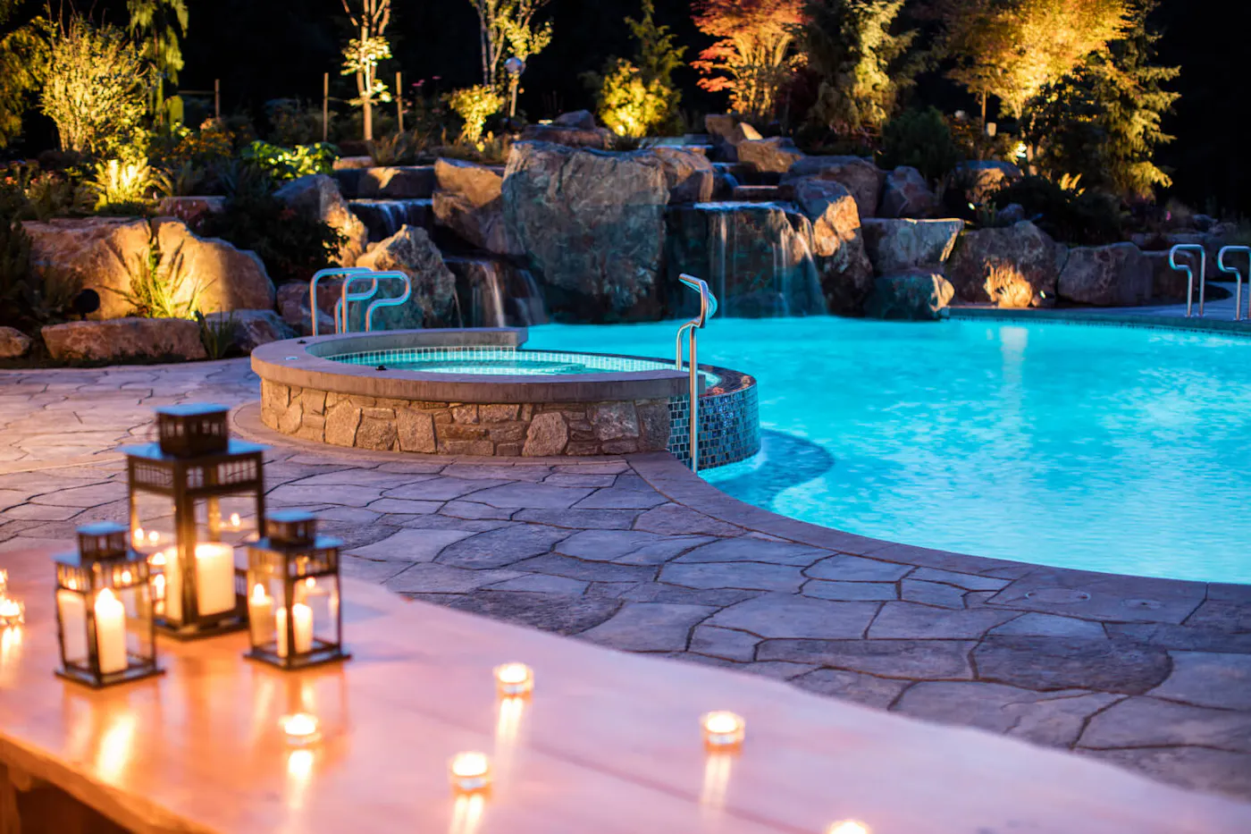 image of pool with hot tub grand flagstone slabs and candles on a table