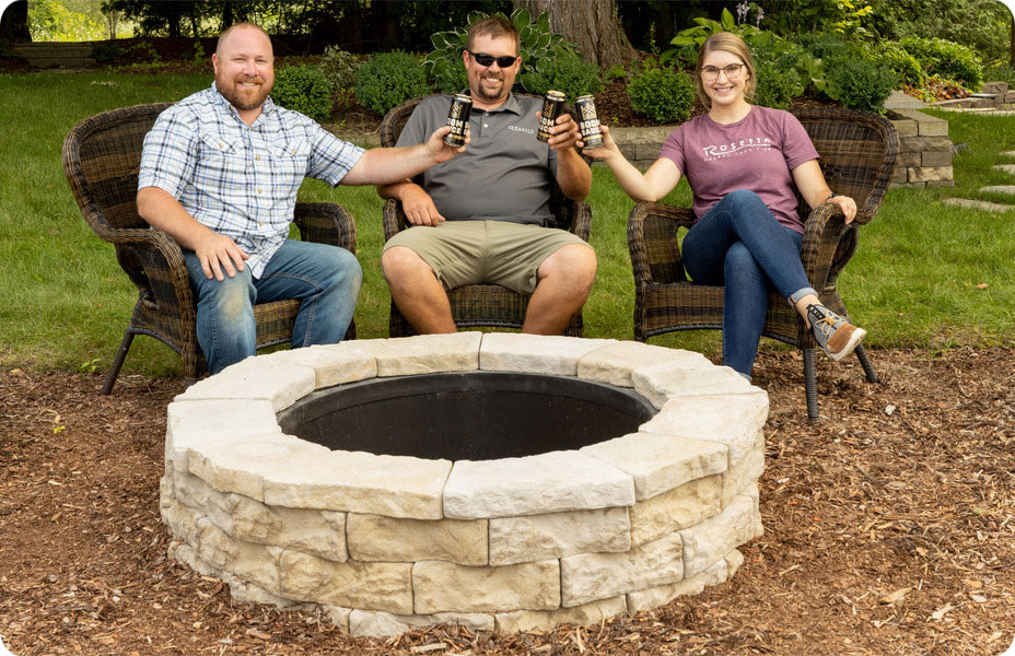 people in cheers next to dimensional wedge fire pit