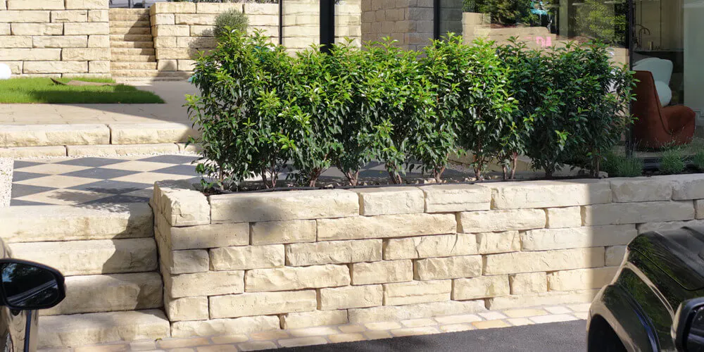 Stone steps integrated with the Grand Ledge wall allow access from the home’s driveway to its entrance and rear patio area.