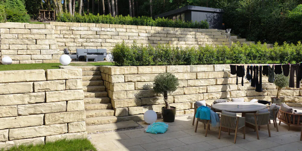 The multiple tiers provide a variety of uses and also support a separate outbuilding.