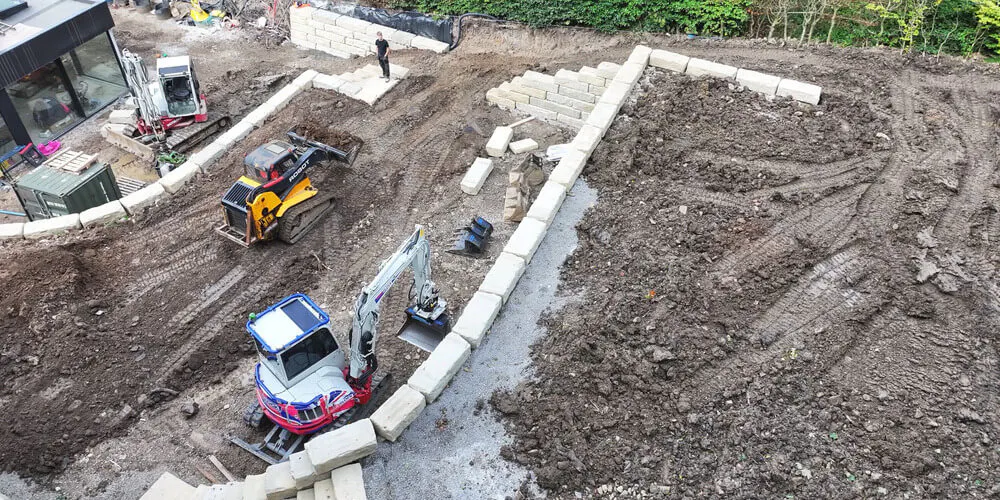 Work begins on the installation of the Grand Ledge retaining walls at the Mellor residence.