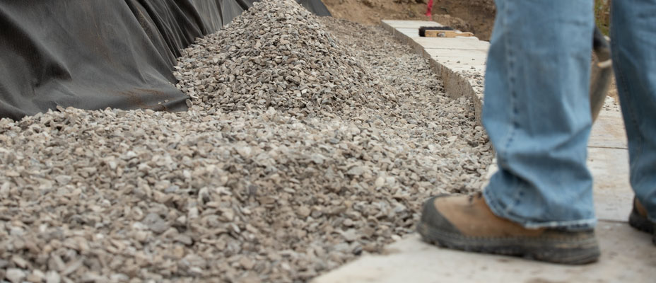 image of worker backfilling grand ledge wall