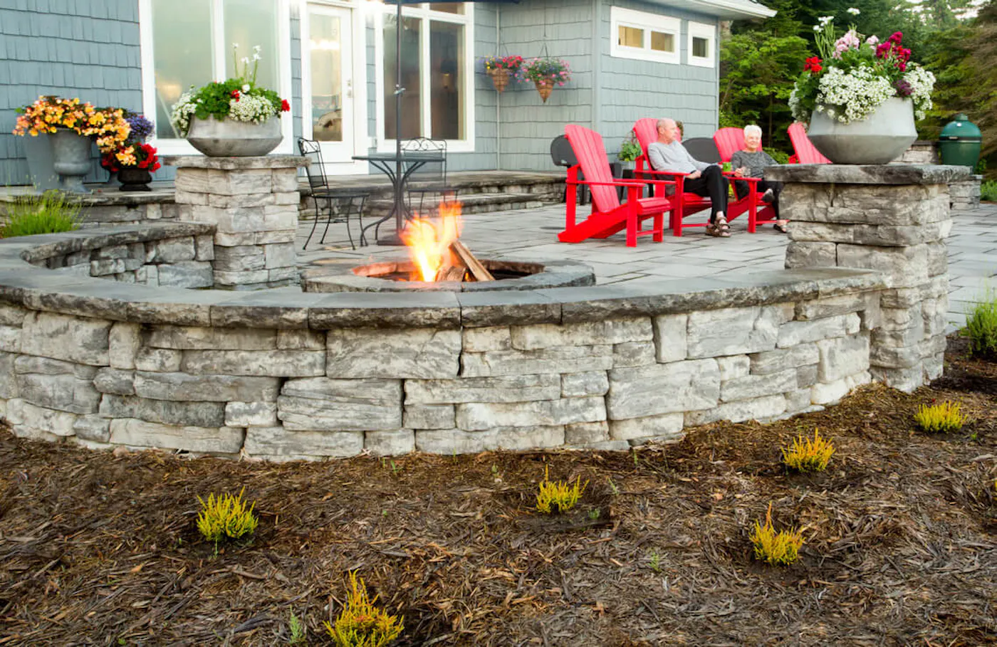 belvedere walll surrounding firepit with couple sitting in lounge chairs