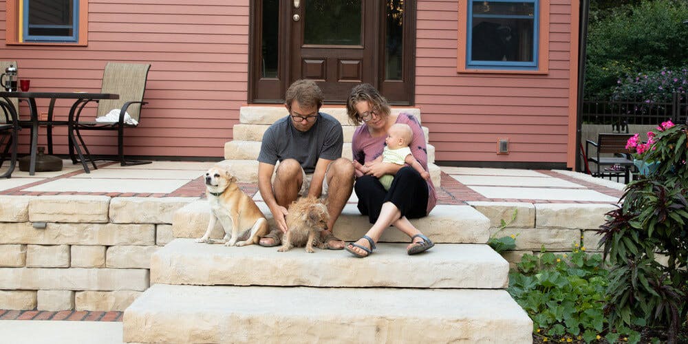 people on steps in front of house