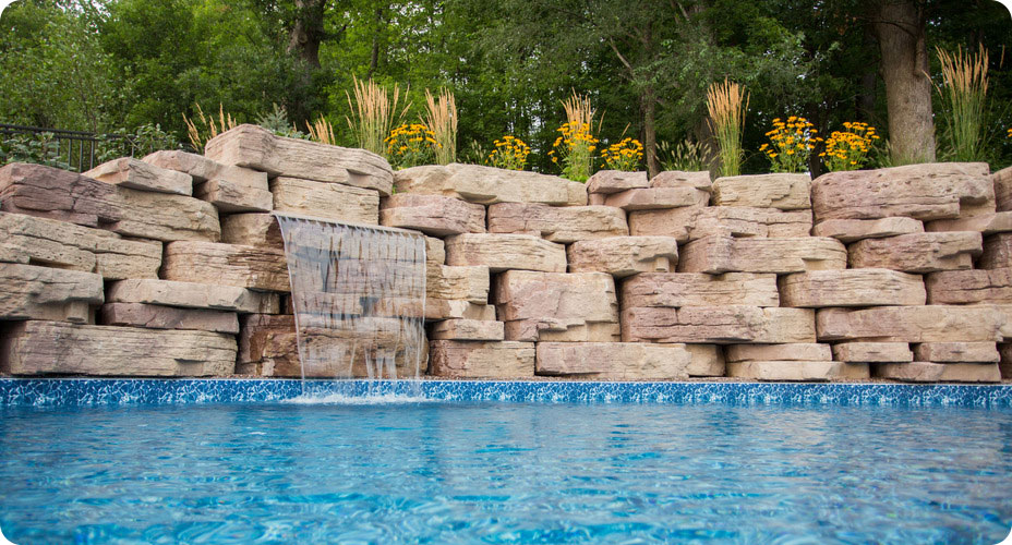 outcropping wall for pool with water feature in wall