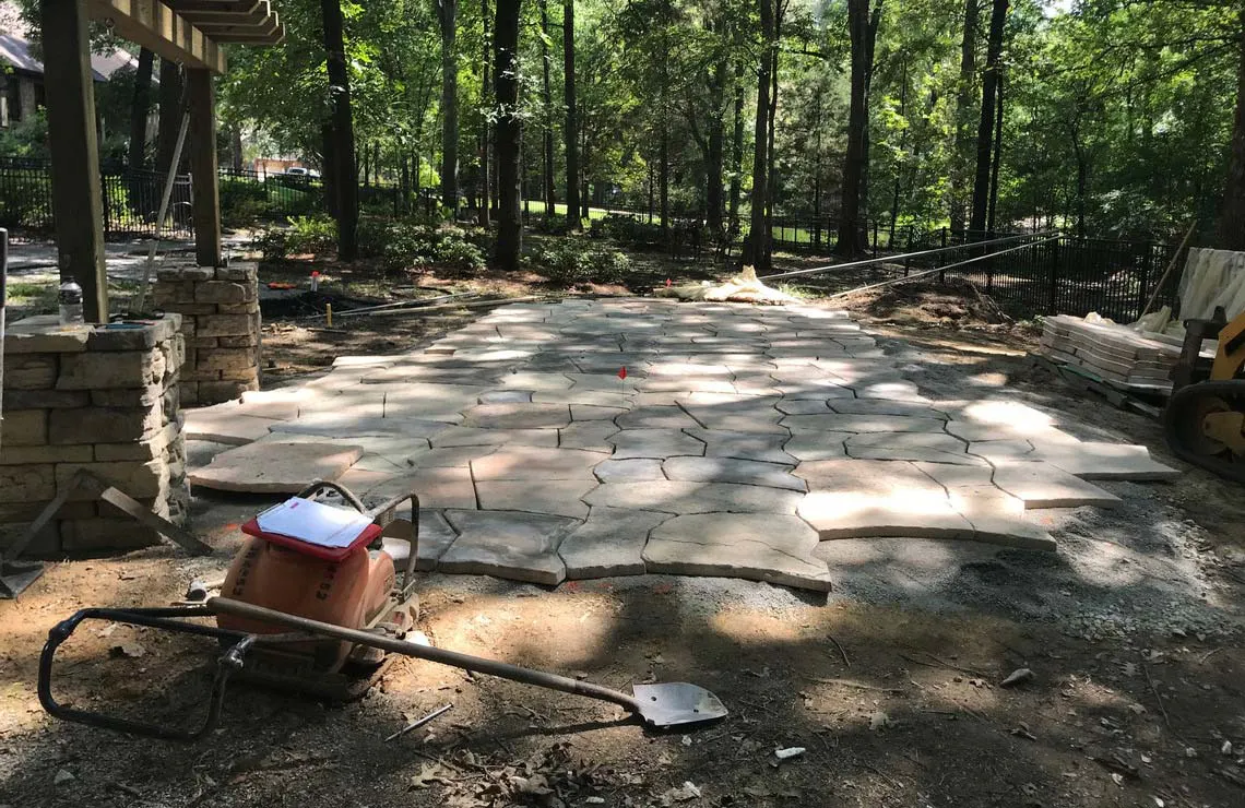 A Rosetta Hardscapes backyard Grand Flagstone patio project in progress.