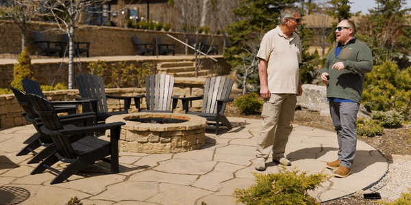 image of rosetta hardscapes fire pit area with 2 people talking