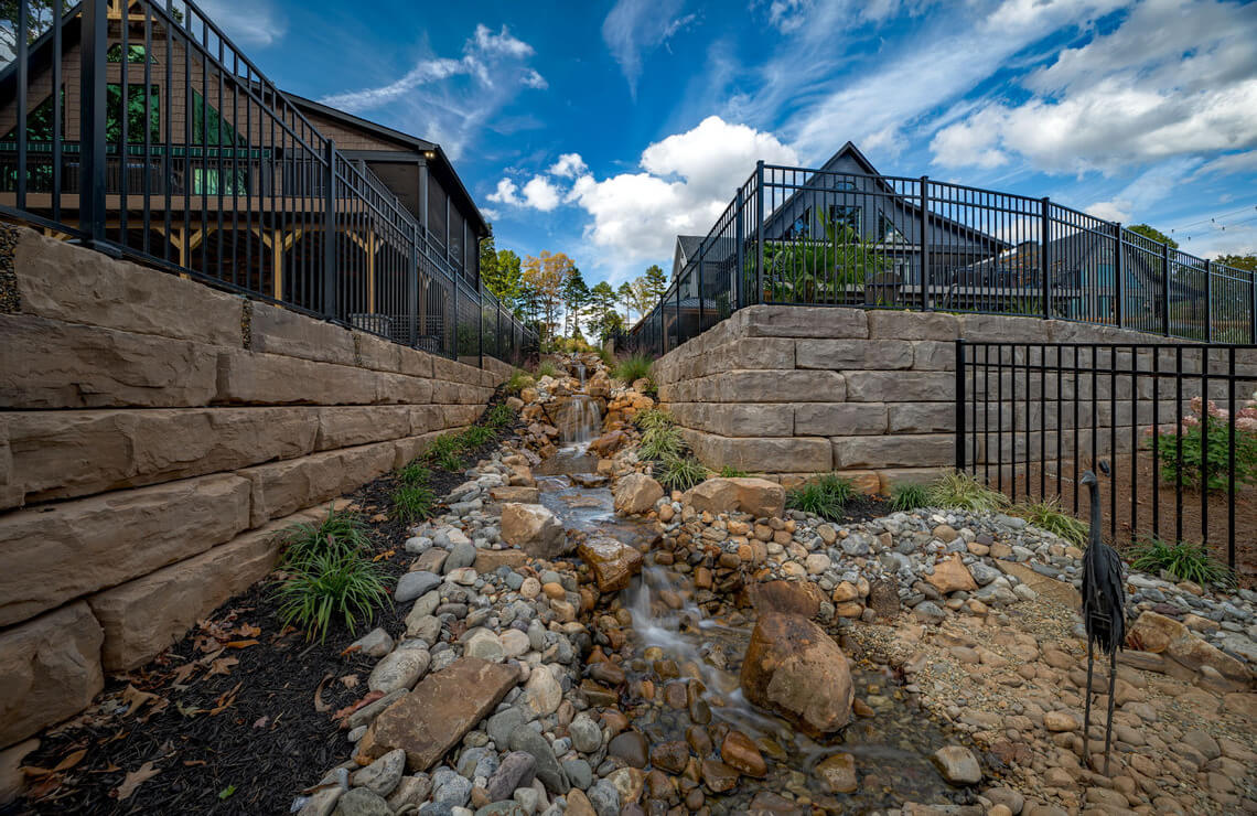 image of small waterfall between two houses using Rosetta Grand Ledge retaining walls