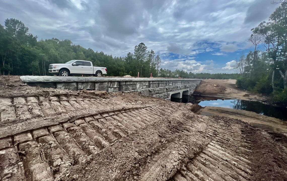 image of box culvert bridge almost finished with redi-rock wall