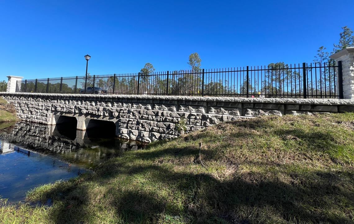 image of finished box culvert bridge with redi-rock wall