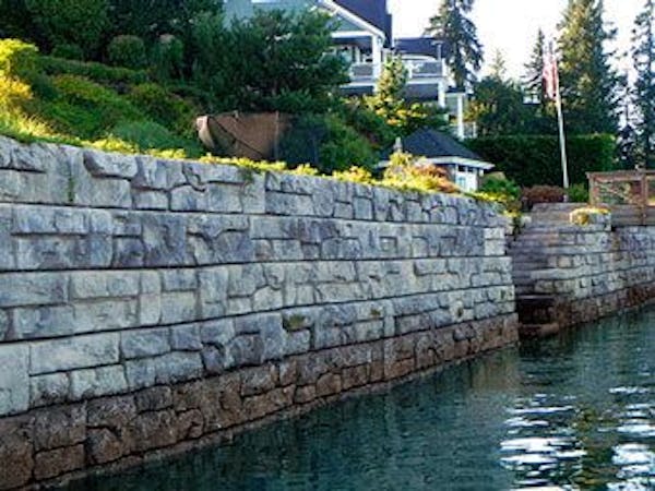 Redi-Rock Ledgestone retaining wall in seawall application for residential home in marine/salt-water environment.