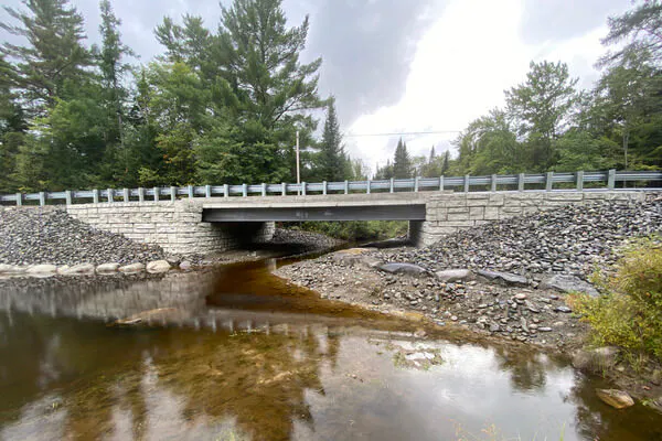 A completed Velpont bridge crossing system demonstrates a proper stream crossing application and the strength of precast concrete construction.